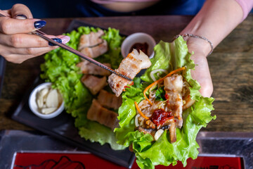 Hot asian meat dish with lettuce leaf