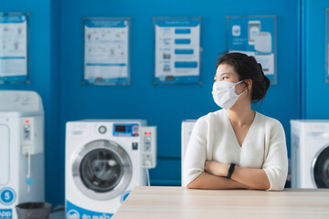 portrait asian female wear virus protecting mask in spread of covid-19 washing  in blue color...