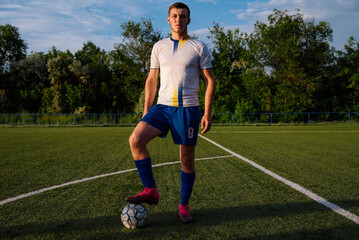 Close up of soccer player with ball on soccer field © bo.kvk