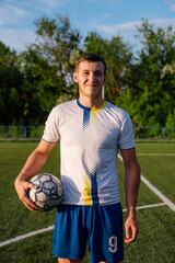 Soccer player with a ball in his hands