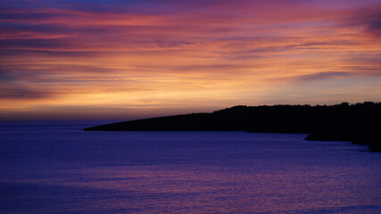 the sunset in Cala Ratjada on the island Mallorca, Spain, in the month of January