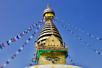 Old Buddhist Stupa in Himalaya on Bright colorful clear sunset sky background. Traditional buddhist architecture. Pagoda in Nepal mountains on bright and colorful cloudscape background.Buddhist symbol