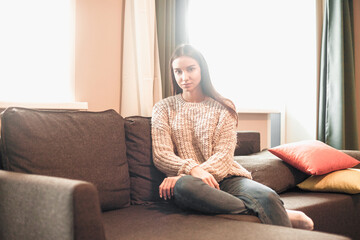 Young woman pretty relaxing on couch in living room