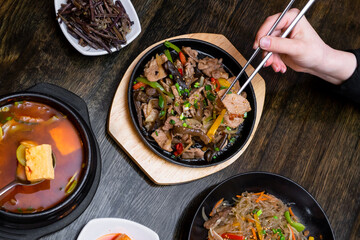 Lunch table with asian meat dishes 