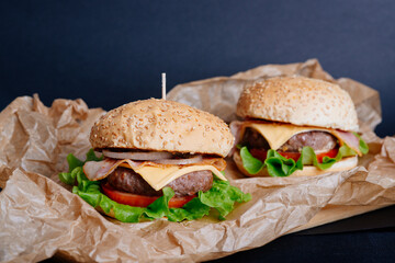 View of fresh tasty burger on wooden table. Food background.