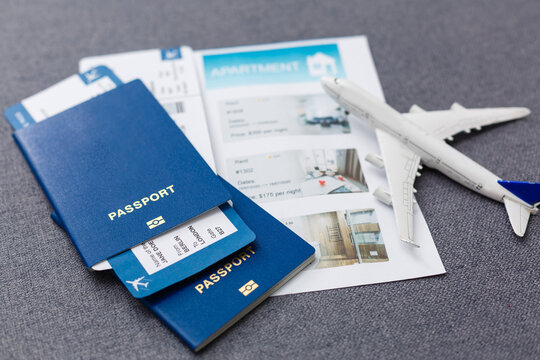 White blank model of passenger plane on passports with boarding pass on blue rustic wooden background