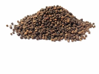 Dry Black peppercorns heap on white background sideview .