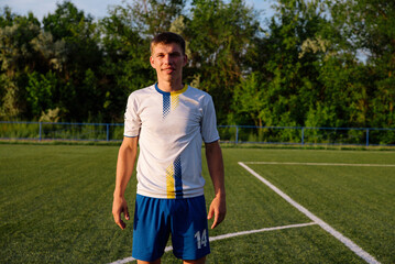 Close up of soccer player with ball on soccer field