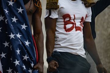 cropped photo of black people holding American flag while protest, BLM concept. anti-racism