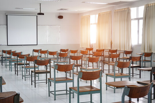 Empty Classroom With Vintage Tone Wooden Chairs. Classroom Arrangement In Social Distancing Concept To Prevent COVID-19 Pandemic. Back To School Concept.	