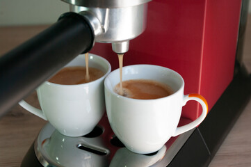 cups with espresso coffee. Morning breakfast drink. Red coffee machine. Close up. Mockup