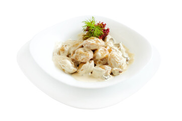 Slices of mushrooms and meat with white sauce on white background