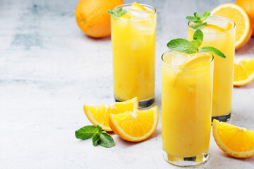 Glasses full of orange juice with ice