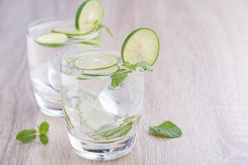Mojito cocktail in a bur on a rustic table, mojito cocktail with fresh lime and mint on a wooden...