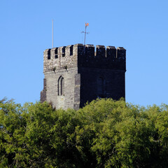View of old church tower rising above the trees