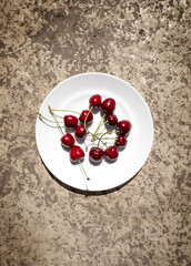 sweet cherries on a white plate