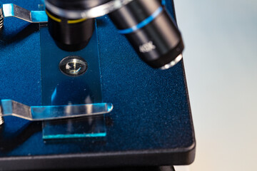 Microscope with lenses close up against dark background
