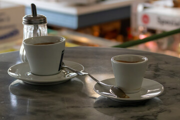 two empty coffee cups on a bistro table