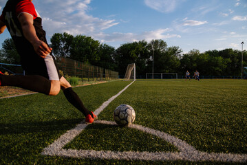 Soccer player kicks the ball.Soccer player takes a corner kick