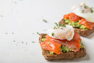 Sandwich with salmon, avocado and whole grain bread