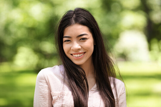 Asian Beauty. Outdoor Portrait Of Smiling Beautiful Korean Girl In Summer Park