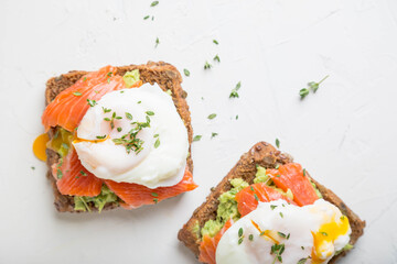 Sandwich with salmon, avocado and whole grain bread