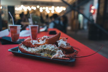 fresh red boiled lobster in paper plate on food festival