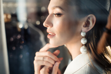 Young girl in a white suit and a black hat. The concept of clothing.