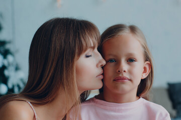 Mother and little daughter child girl at home.