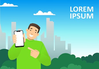 smiling guy with a phone on the background of the city, skyscrapers; shows a blank screen of the phone, points to it with a finger; copy space horizontal