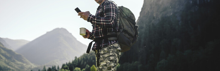 hiker men holding smart phone outdoors