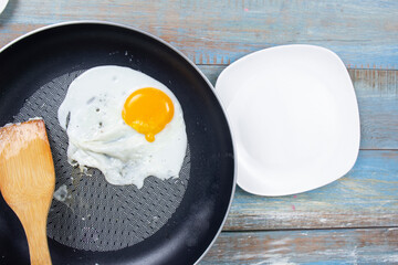 Chef frying egg in the pan