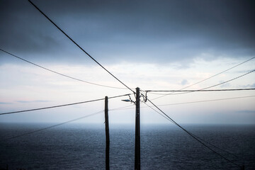 wooden pylon with wires