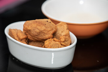 An image of fried bean cake with garrison and water