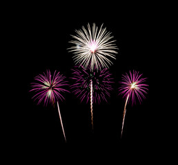 Colorful festive fireworks exploding over night sky, isolated on black background
