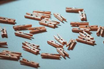 A lot of small wooden clothespins on a white background.