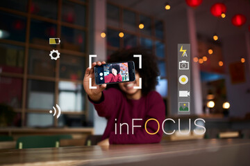 Selective focus on modern smartphone held by African American hipster girl taking photo for social...