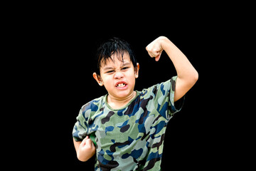 An Asian boy looks strong,Healthy boy concept, child showing the muscle on the black background,People on the isolated background.
