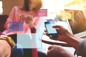 Close up of group of friends holding mobile phone and sharing online multimedia files. Millennial smartphone users communicating via applications. Infographics message icons, chatting symbol