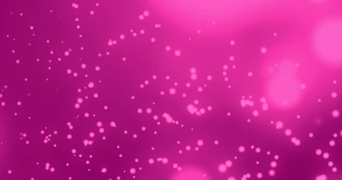 Glowing spots moving against pink background 