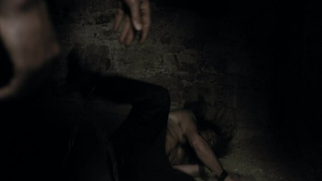 Shirtless Man In Shackles Pushed Into Dark Prison Cell By Guard