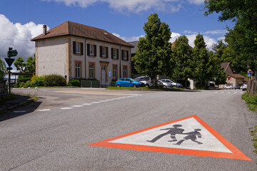 PINET, FRANCE, June 19, 2020 : The village school and a painted road sign. © Pierre-Jean DURIEU
