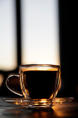 cup of coffee on the table at sunset