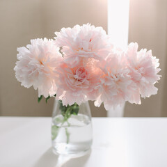 Beautiful pink peonies in a vase at home interior. Flower composition. Floral shop concept. Beautiful fresh cut bouquet. copyspace