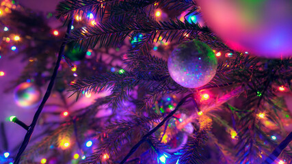 Christmas lights at night on a christmas tree decorated with balls