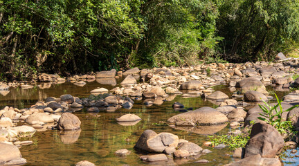 Small stream of fresh water and rolled stones in the interior of Brazil