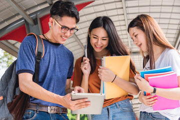 Group students studying outdoors consult