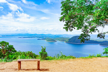 Lookout point with resting wooden bench. Beautiful scenery of nature with a large reservoir above...