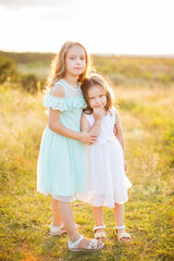 Fototapeta premium Two adorable girls sisters having fun outdoors.
