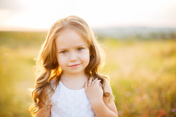 Fototapeta na wymiar Portrait of beautiful cute little girl outdoors.